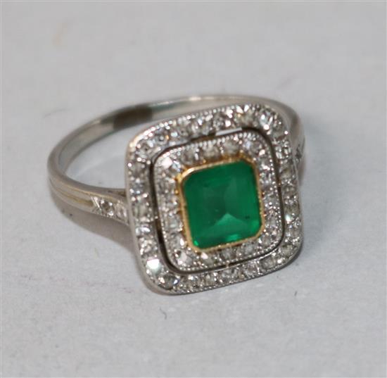 A white metal, emerald and diamond tablet cluster ring, size K.